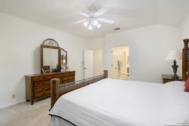 a bedroom with a bed and a dresser