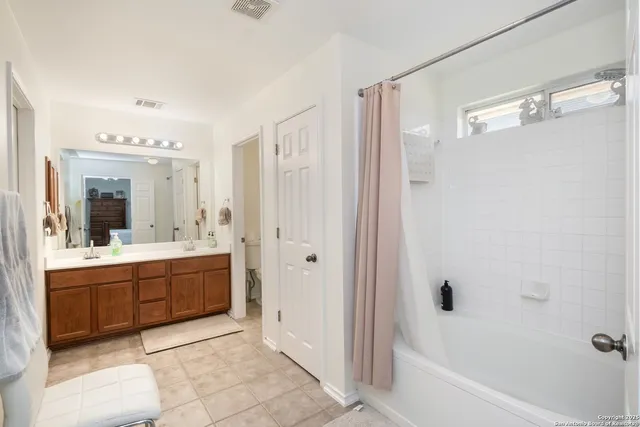 a bathroom with a tub sink shower and mirror