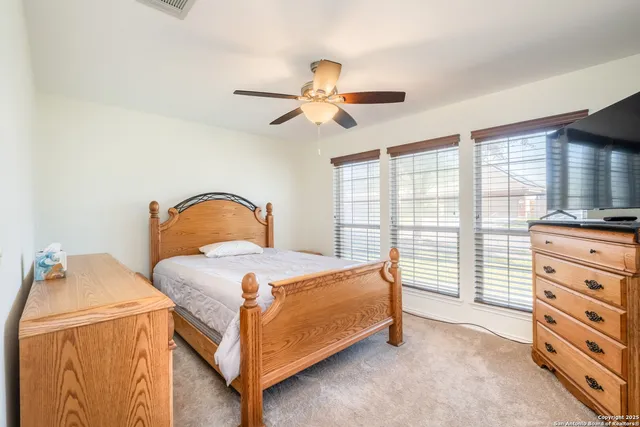 a large bed sitting in a bedroom next to a window