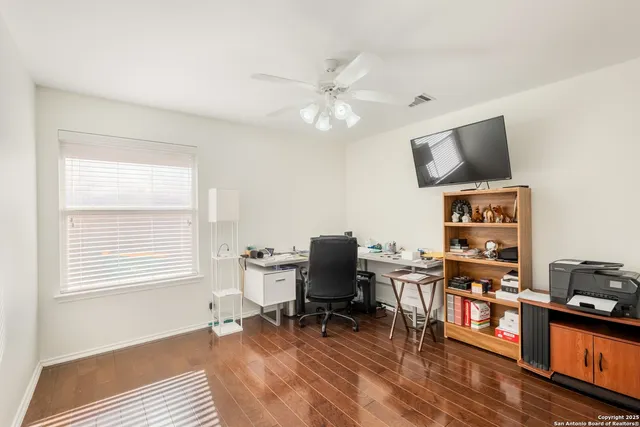 a workspace with wooden floor and a window