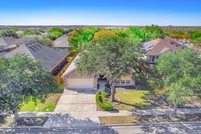 an aerial view of residential houses with outdoor space and swimming pool