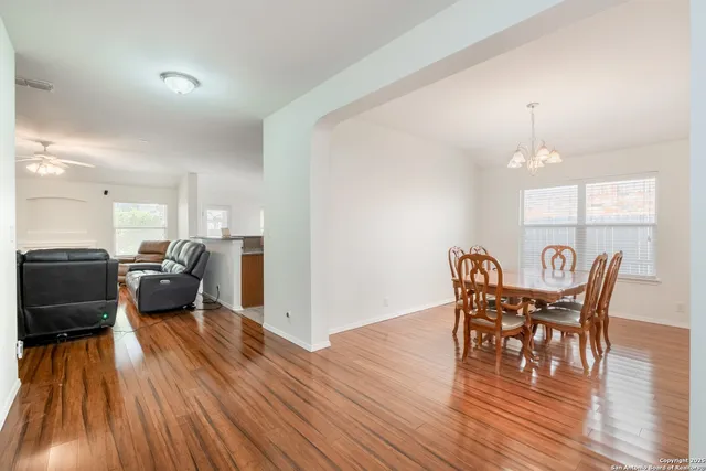 a view of a dining room with furniture and wooden floor
