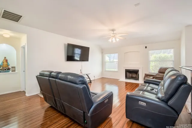 a living room with furniture a fireplace and a flat screen tv