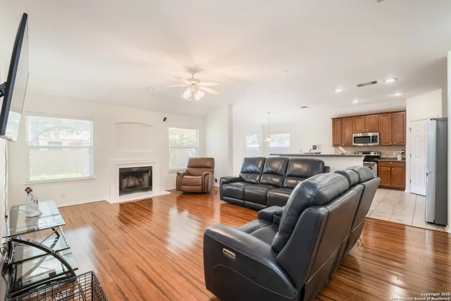 a living room with furniture fireplace and flat screen tv