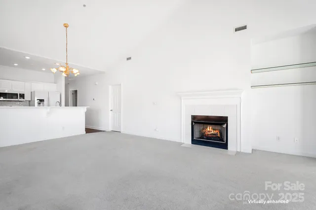a view of an empty room with fire place and a fireplace