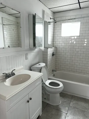 a bathroom with a sink a toilet and bathtub