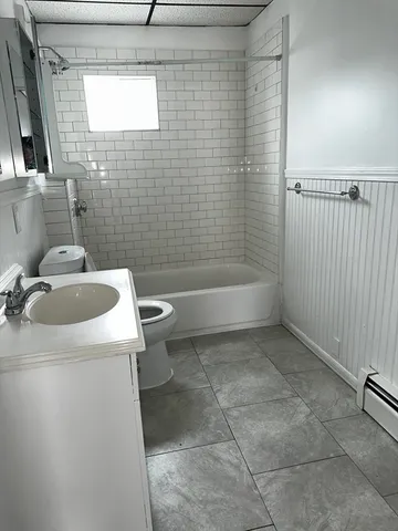 a view of a car parked in front of a white house