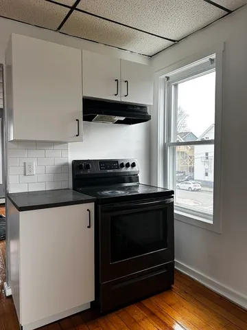 a kitchen with stainless steel appliances a stove a microwave and wooden cabinets