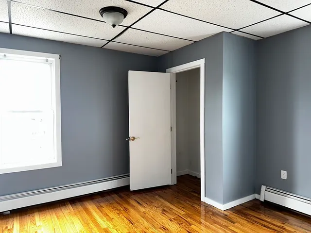 a view of room with window and wooden floor