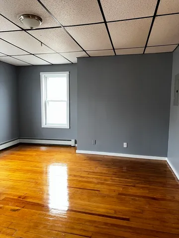 a view of a room with window and wooden floor