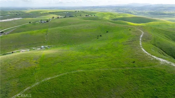 a view of a field with an ocean