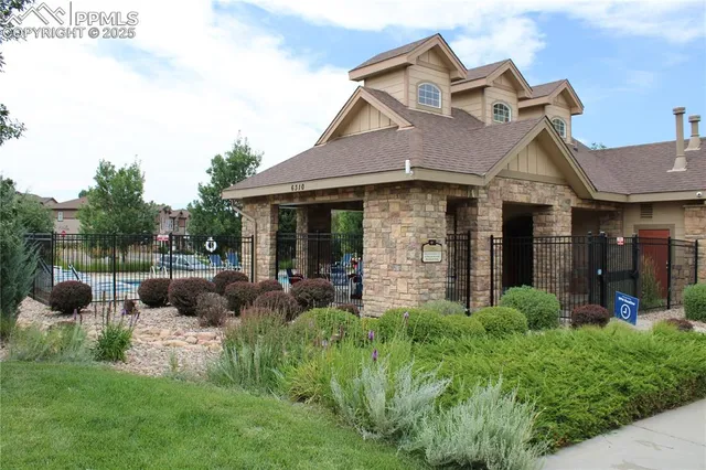 a view of a house with a big yard and potted plants