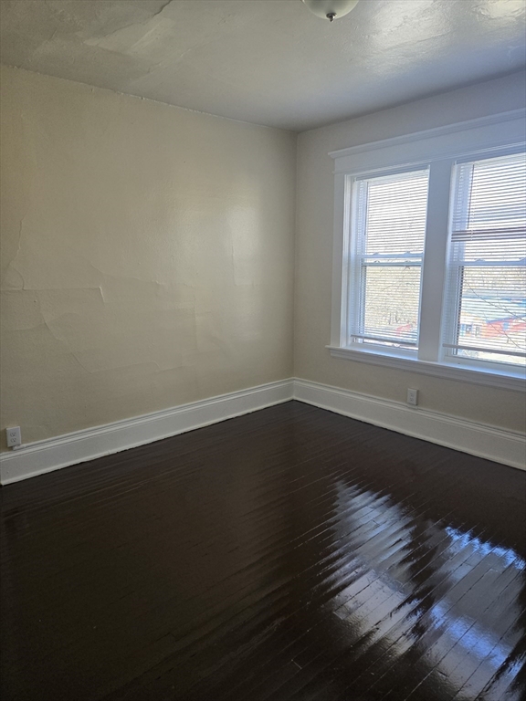 240 Locust Street, Unit 4L Springfield, MA 01108 - Photo 11 of 12 a view of wooden floor and windows in a room