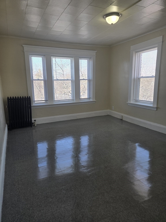 240 Locust Street, Unit 4L Springfield, MA 01108 - Photo 2 of 12 a view of an empty room with wooden floor and a window