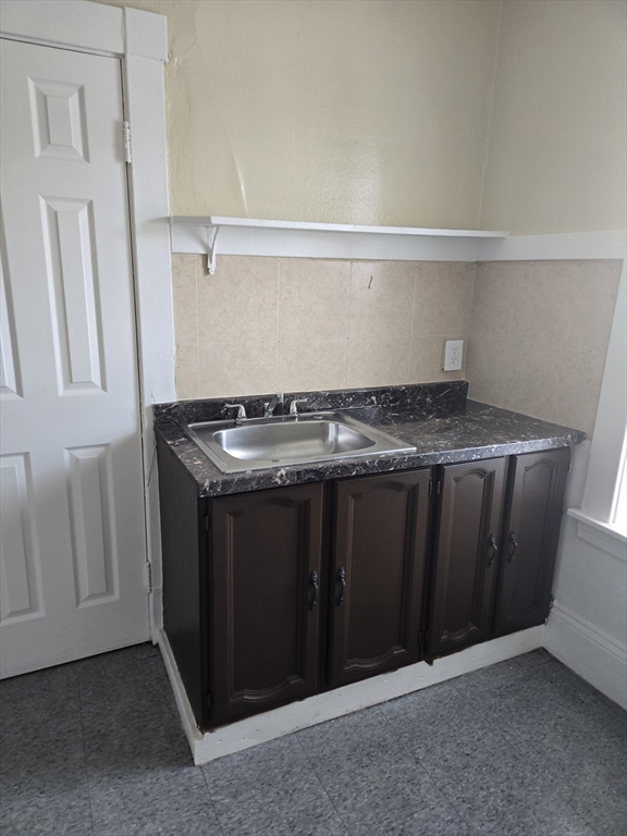 240 Locust Street, Unit 4L Springfield, MA 01108 - Photo 6 of 12 a kitchen with granite countertop a sink a stove and cabinets