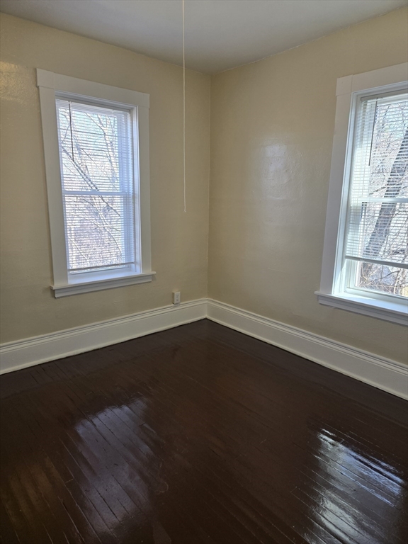 240 Locust Street, Unit 4L Springfield, MA 01108 - Photo 8 of 12 a view of an empty room with wooden floor and a window