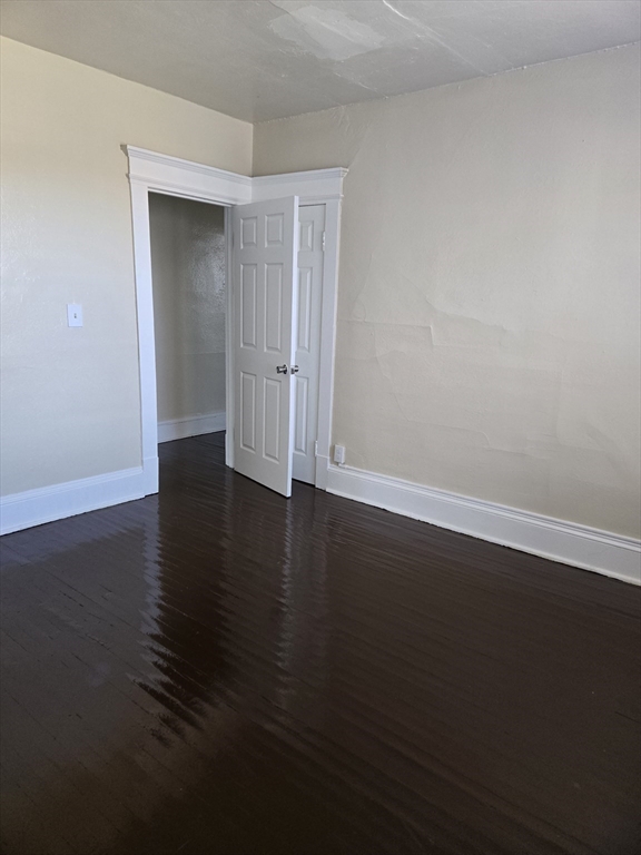 240 Locust Street, Unit 4L Springfield, MA 01108 - Photo 10 of 12 a view of a room with wooden floor and white walls
