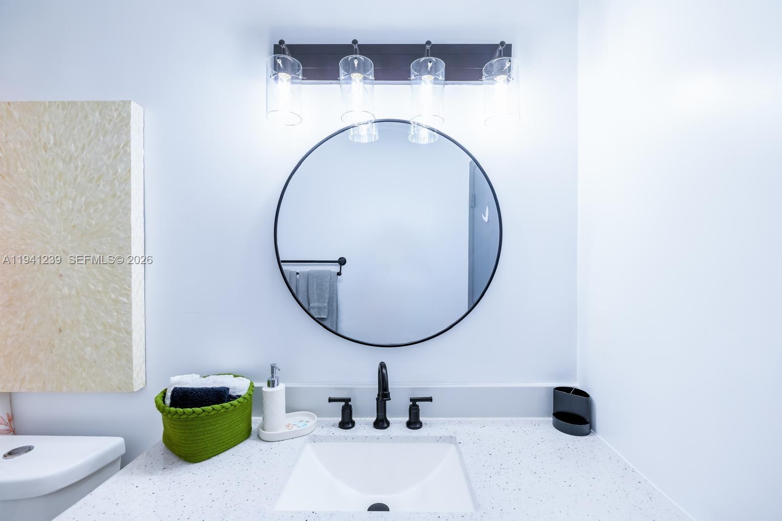 312 North Luna Court Hollywood, FL 33021 - Photo 11 of 60 a bathroom with a sink and a mirror