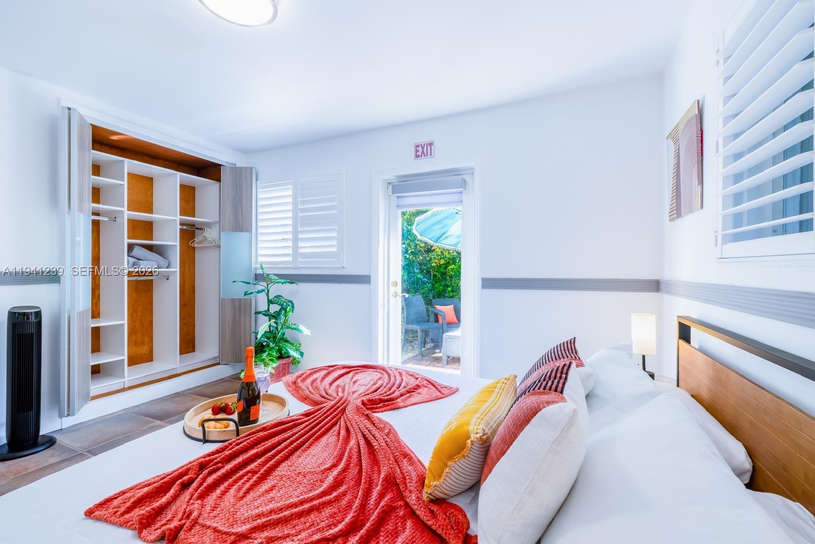 312 North Luna Court Hollywood, FL 33021 - Photo 13 of 60 a bedroom with a bed and a potted plant