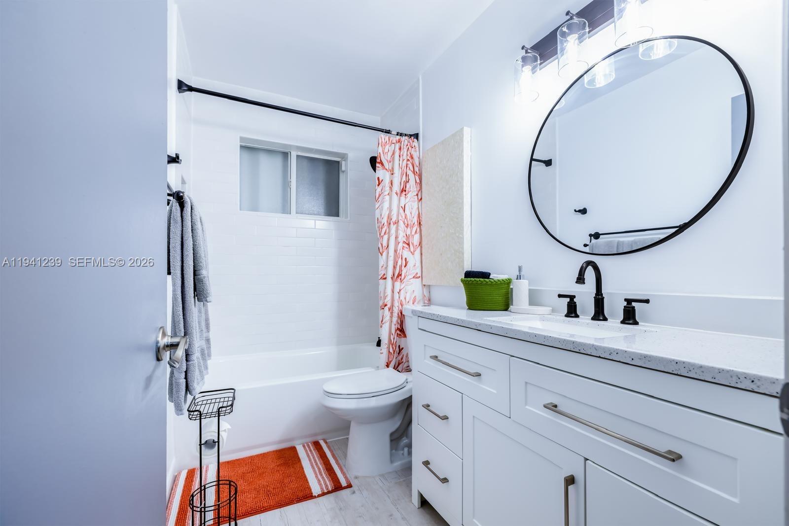 312 North Luna Court Hollywood, FL 33021 - Photo 24 of 60 a bathroom with a sink a toilet and a mirror