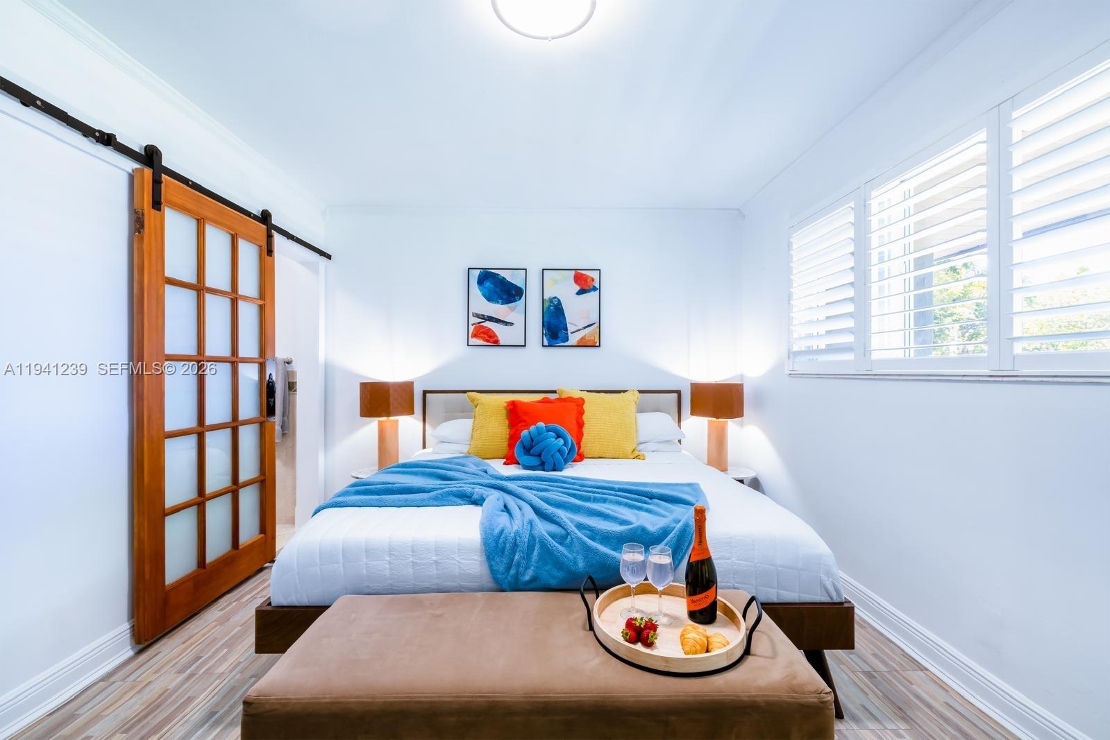 312 North Luna Court Hollywood, FL 33021 - Photo 34 of 60 a bedroom with a bed and a window