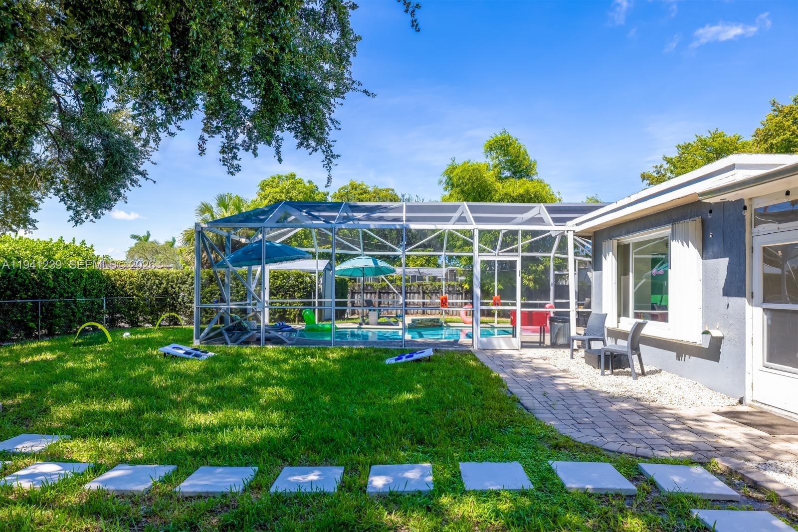 312 North Luna Court Hollywood, FL 33021 - Photo 46 of 60 a view of a house with backyard porch and sitting area
