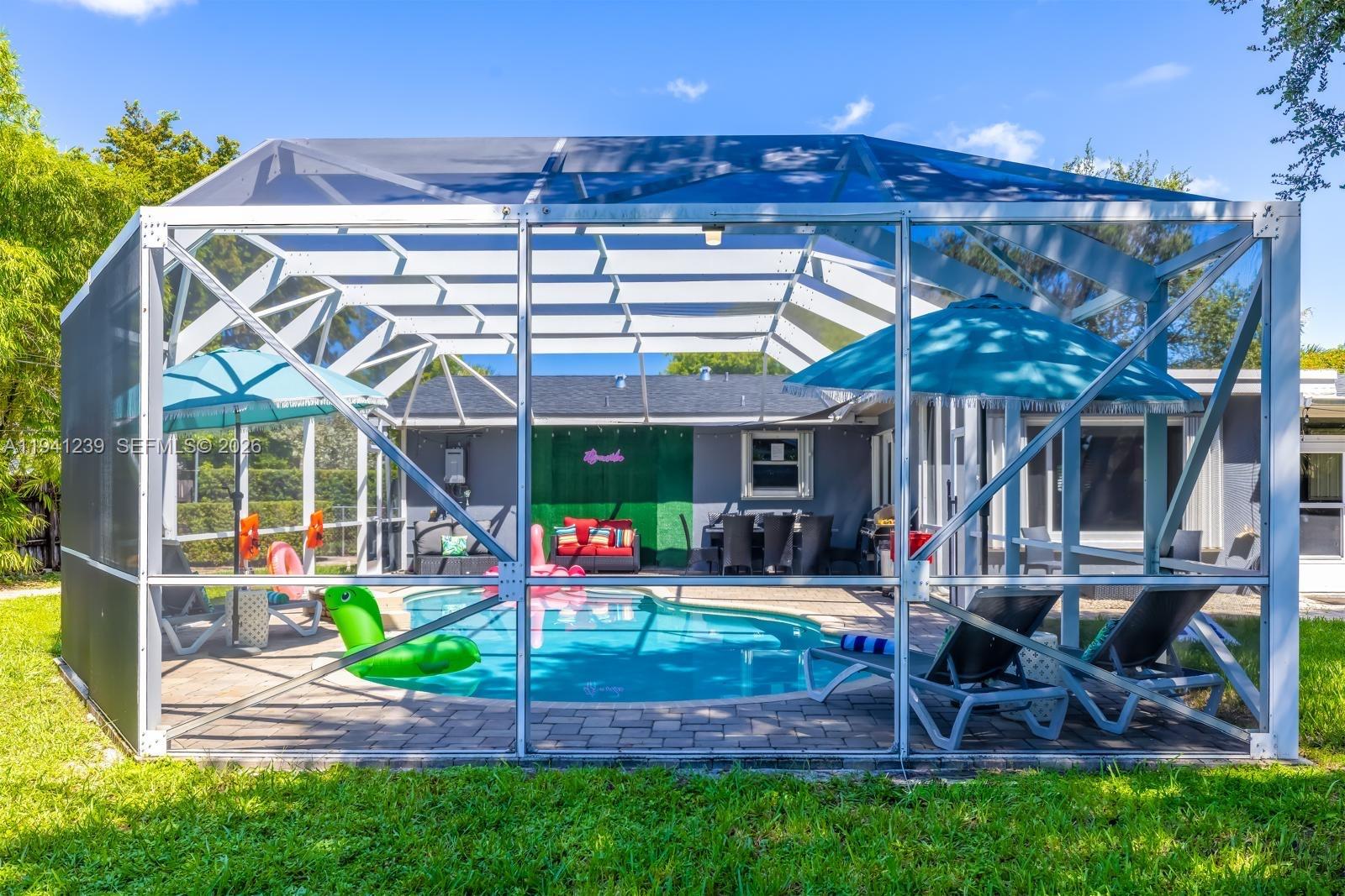 312 North Luna Court Hollywood, FL 33021 - Photo 50 of 60 a view of a chairs and table in backyard