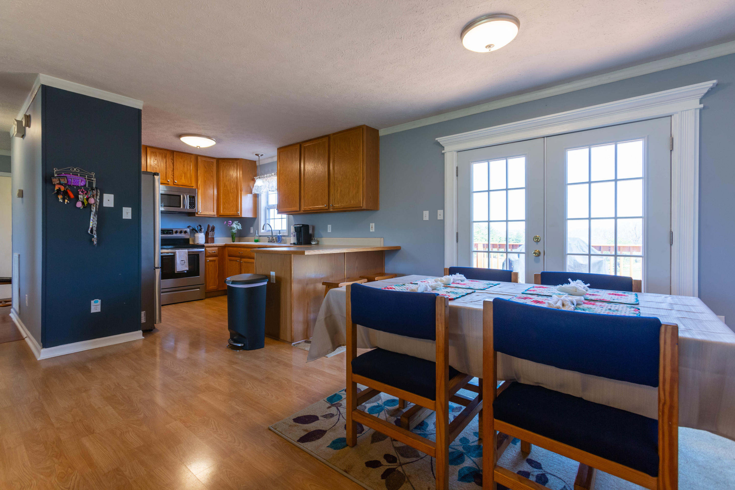 35 Blankenship Road Rocky Mount, VA 24151 - Photo 11 of 36 a dining hall with stainless steel appliances granite countertop a stove a refrigerator a sink a dining table and chairs with wooden floor