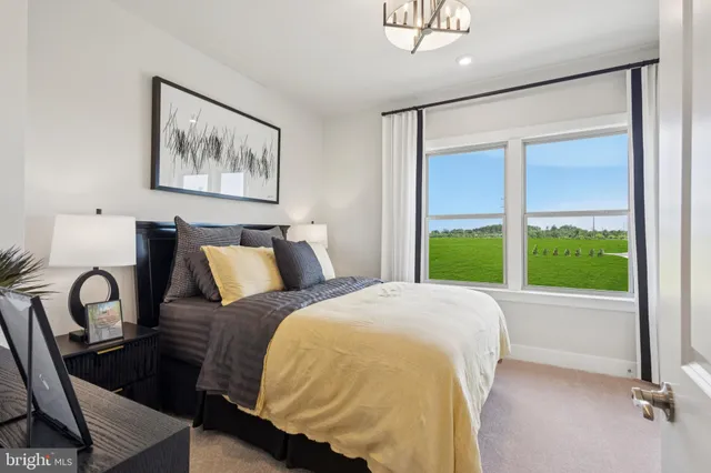 a bed sitting in a bedroom next to a window