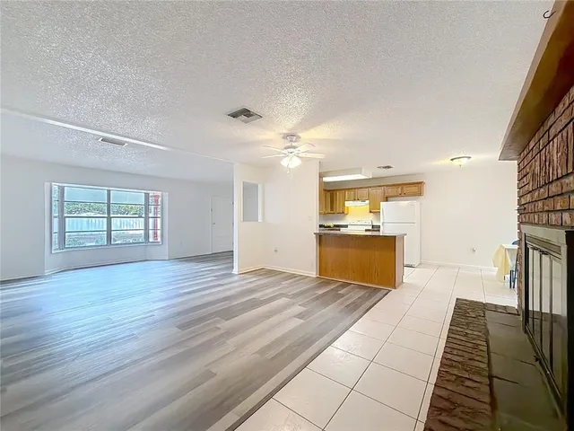 a kitchen with granite countertop a sink cabinets and stainless steel appliances