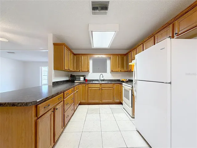 an empty room with a gallery and wooden floor