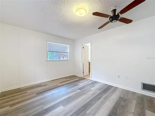 a view of room with wooden floor and walls