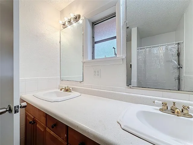 a room that has a bed and a mirror in it