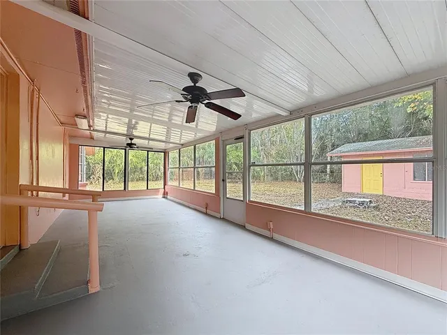 an empty room with a window and a yard