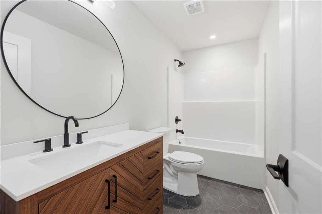 1121 Riverside Terrace Gainesville, GA 30501 - Photo 28 of 39 a bathroom with a sink a toilet and a mirror
