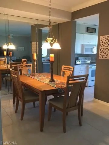 a dining room with a wooden table and chairs