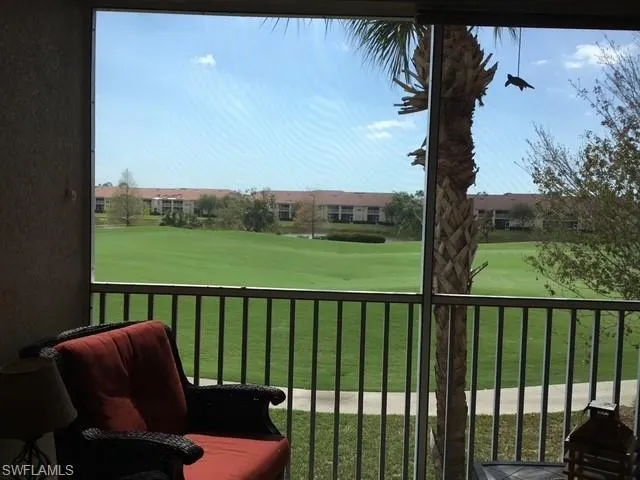 a balcony with view of trees in th background