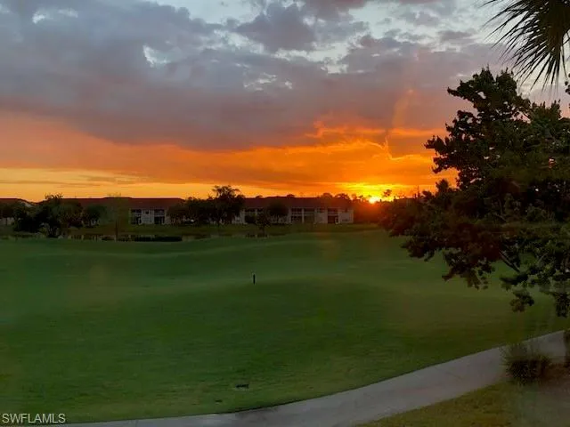 a view of grassy field with mountain