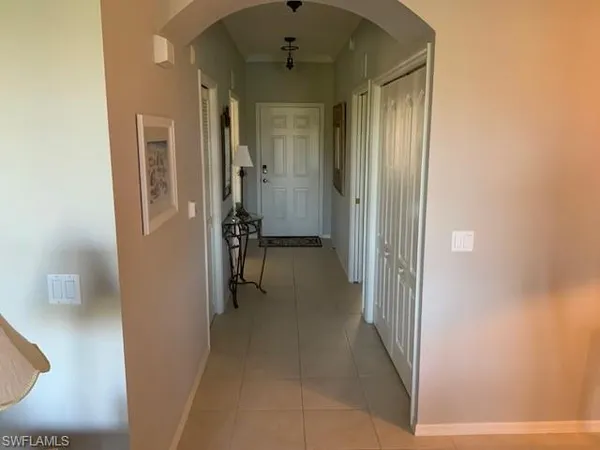 a view of a hallway with a room and a mirror