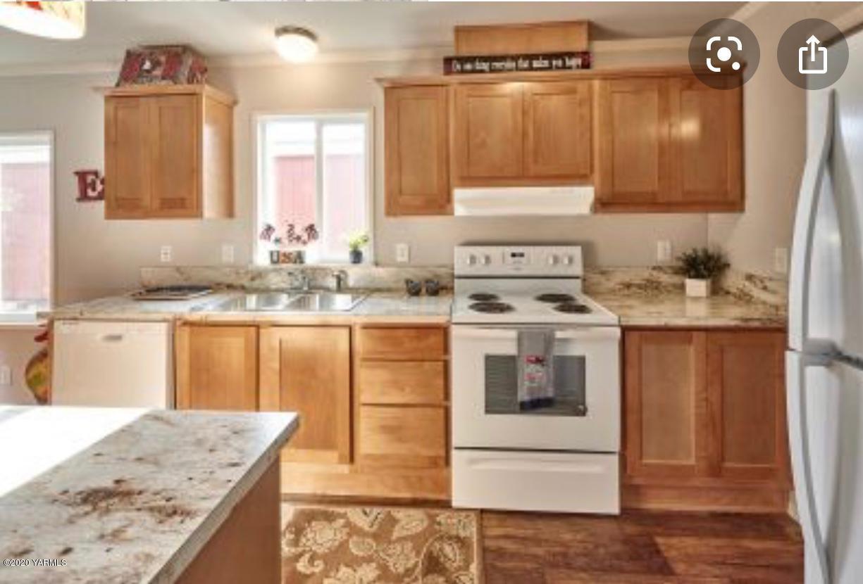 4857 7.8 Road Northeast, Unit 98837 Moses Lake, WA 98837 - Photo 4 of 5 a kitchen with stainless steel appliances granite countertop a sink stove and refrigerator