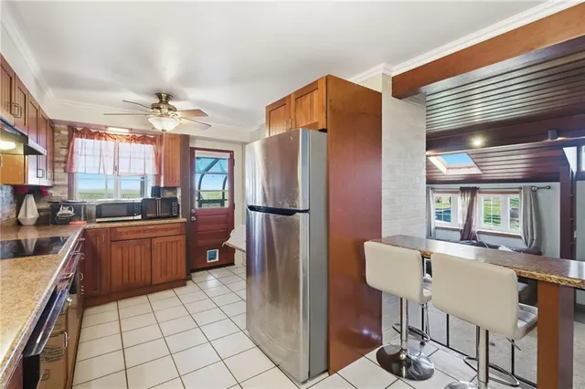 a kitchen with stainless steel appliances granite countertop a refrigerator and a sink