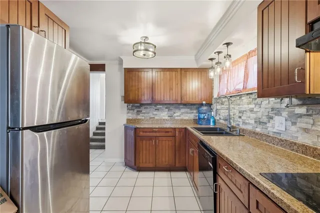 a kitchen with a refrigerator sink and cabinets