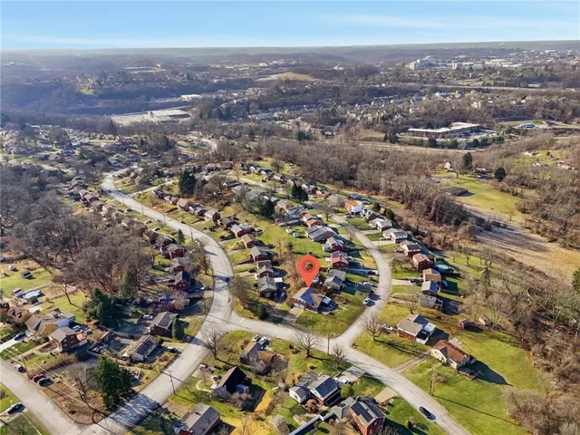 an aerial view of residential houses with city view