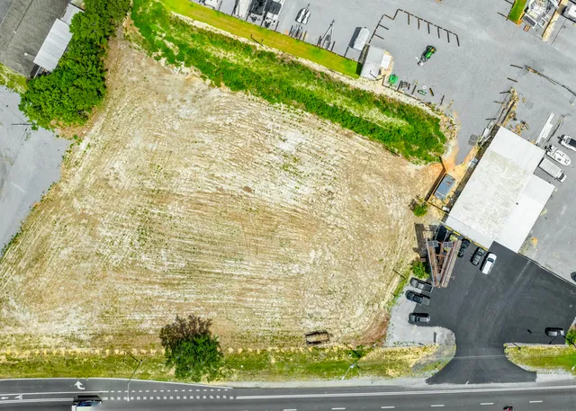a view of swimming pool with lawn chairs and wooden fence