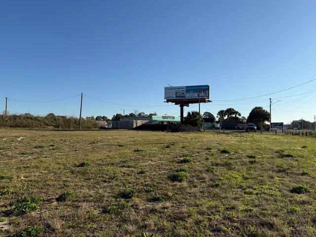 a view of a building with basket ball court and wooden fence