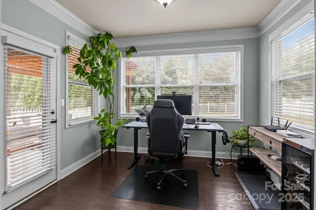 a view of a workspace with furniture and a window