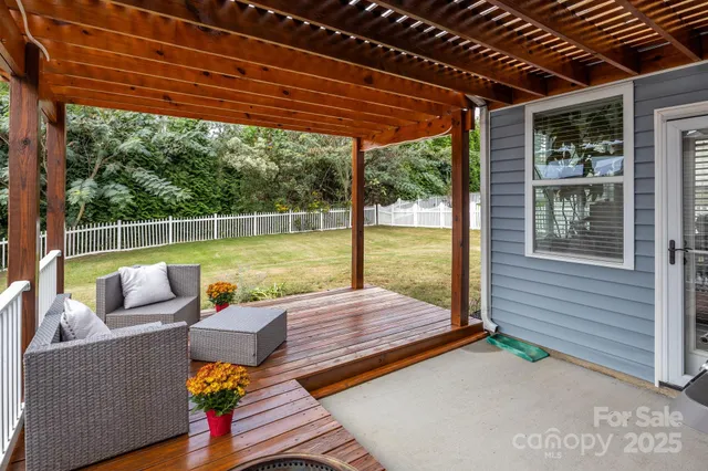 a view of a patio with couches chairs and wooden floor