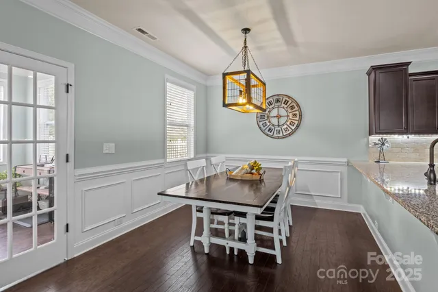 a table and chairs in a room with a window