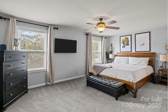 a spacious bedroom with a bed and a chandelier
