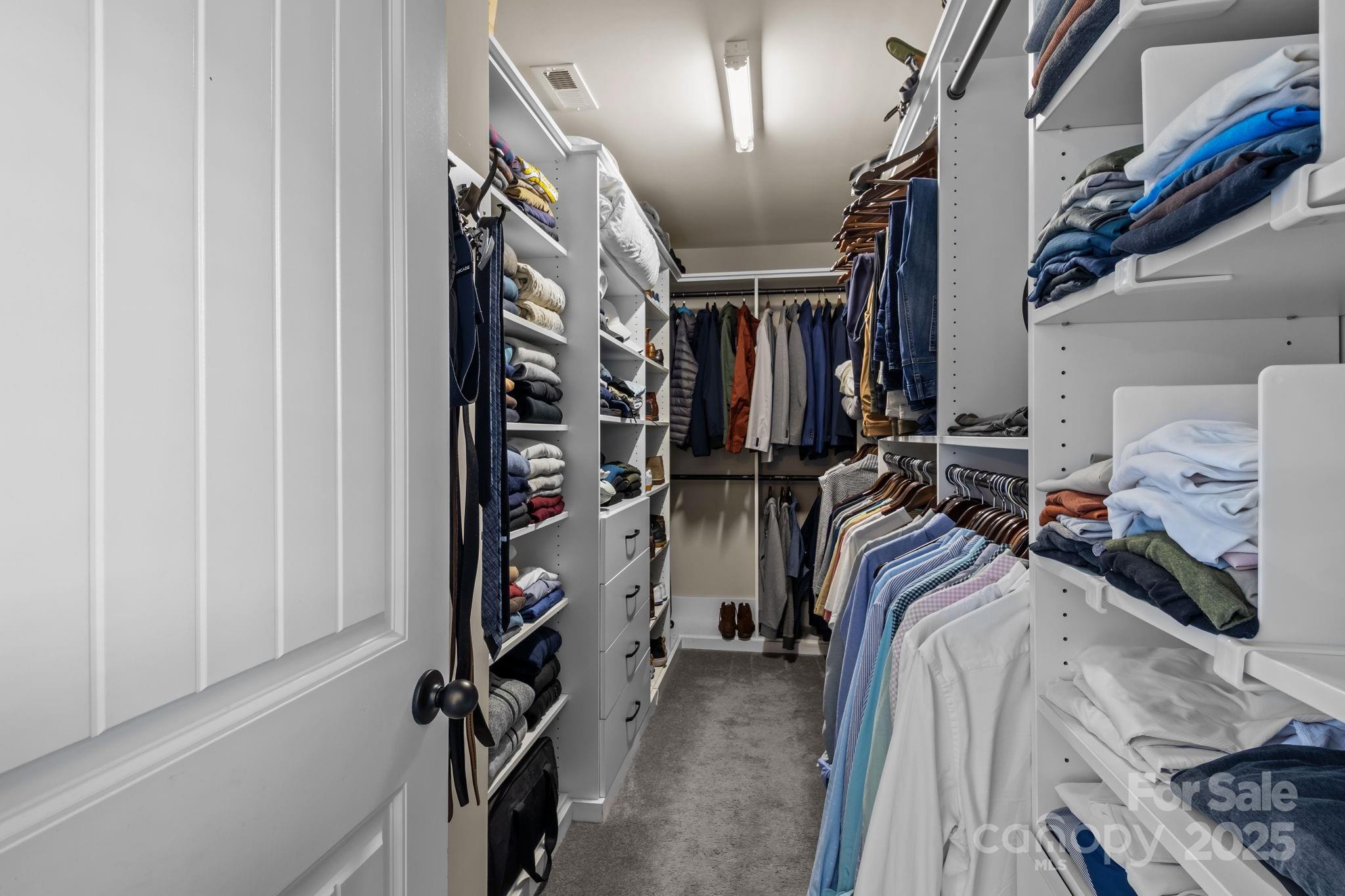 3427 Streamside Drive Davidson, NC 28036 - Photo 9 of 23 a view of walk in closet with clothes and shoes